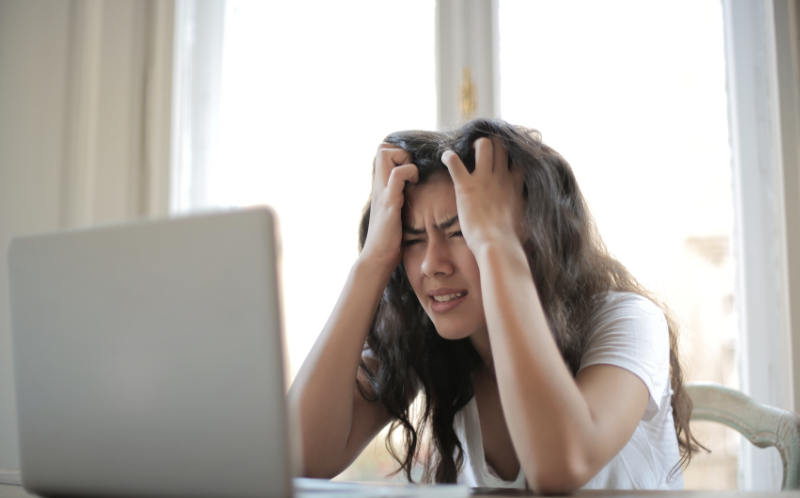 Chica frustrada frente a un laptop